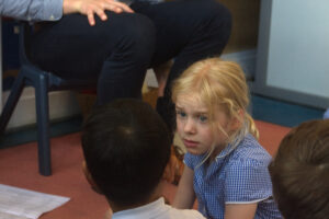 a pupil listening to another speak