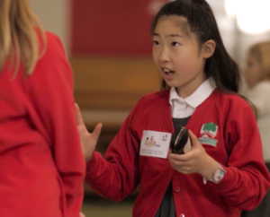 a girl speaking to her talk partner about a question