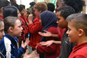 a long line of children debating with their partners