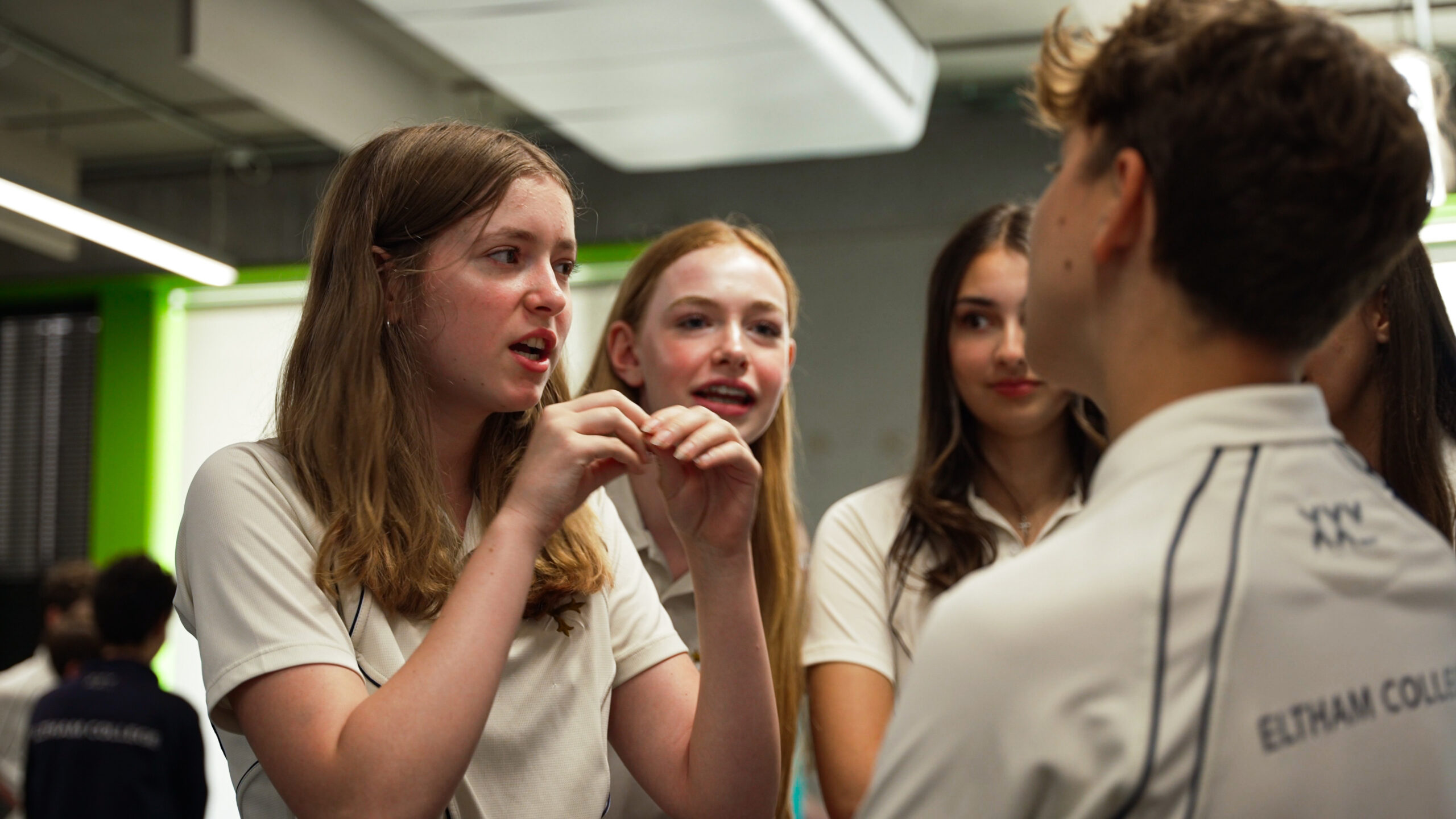 girl speakling to boy who is listening intently