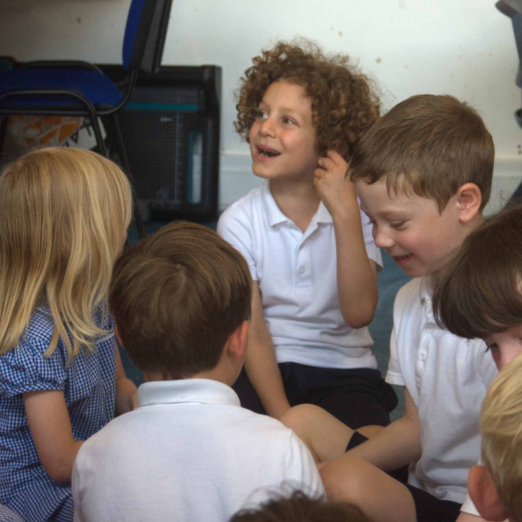 pupil smiling and thinking about a question asked by the teacher